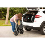 A caregiver folding the Zippie Voyage into the trunk of a car