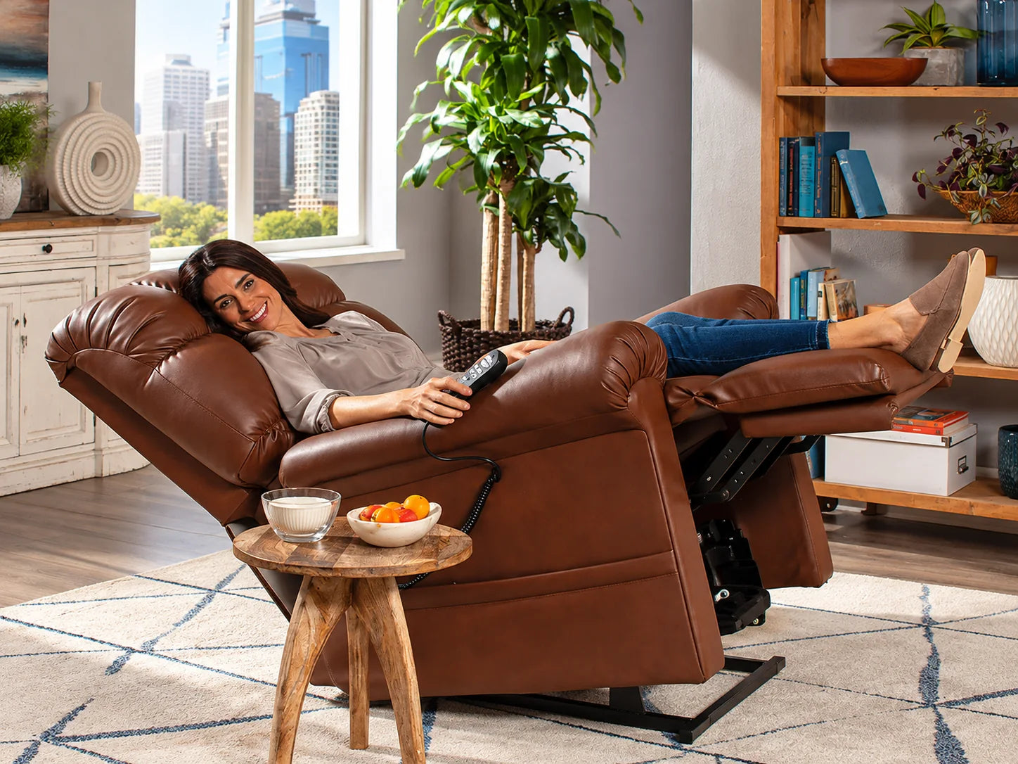 A woman in a brown leather lift chair tilted back with her legs raised above her heart