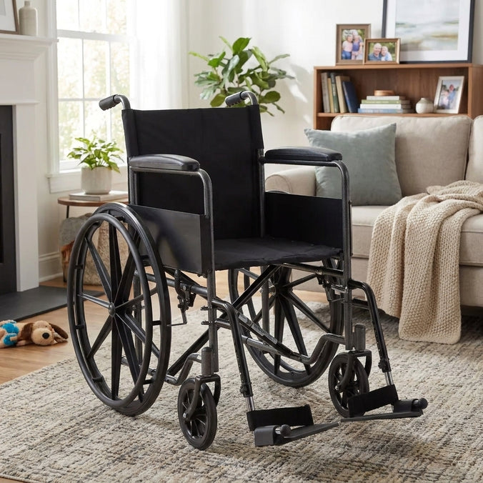 A black steel standard manual wheelchair in a bright living room