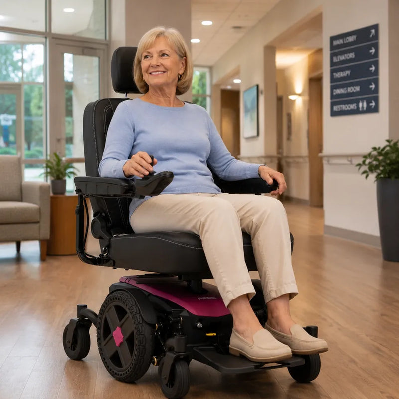 A woman indoors using a full-size power wheelchair