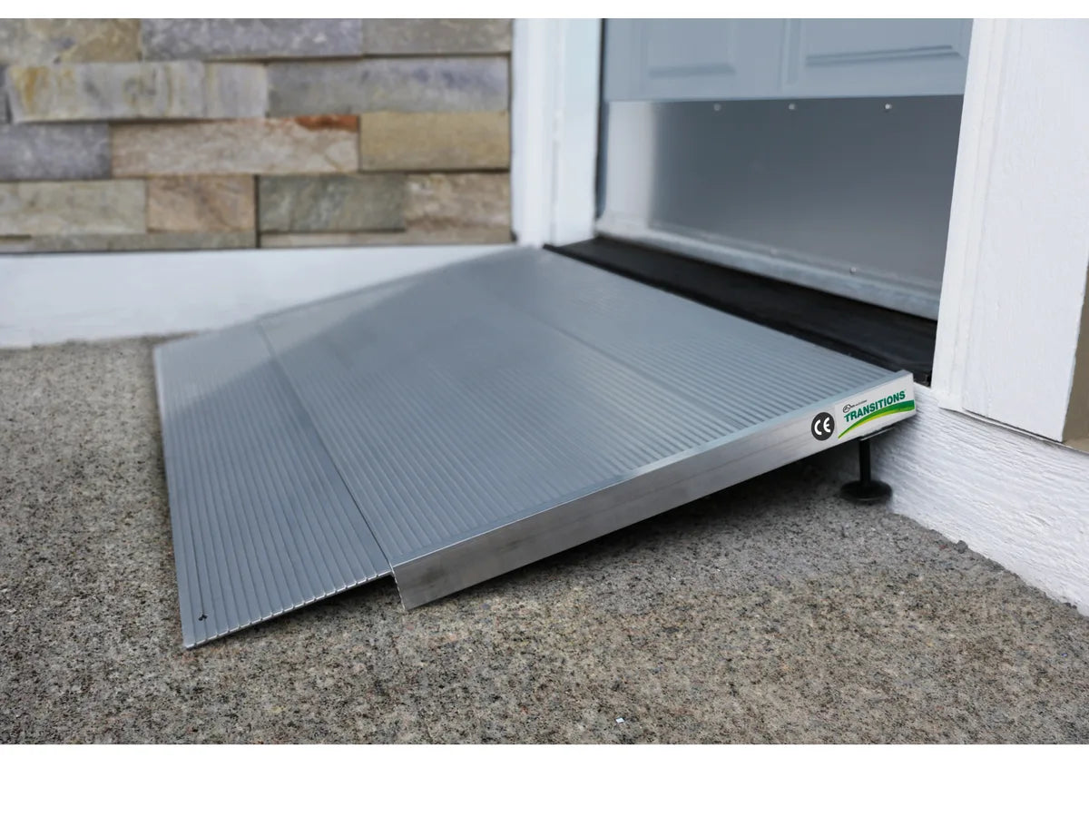 An aluminum threshold ramp at the bottom of an outside door