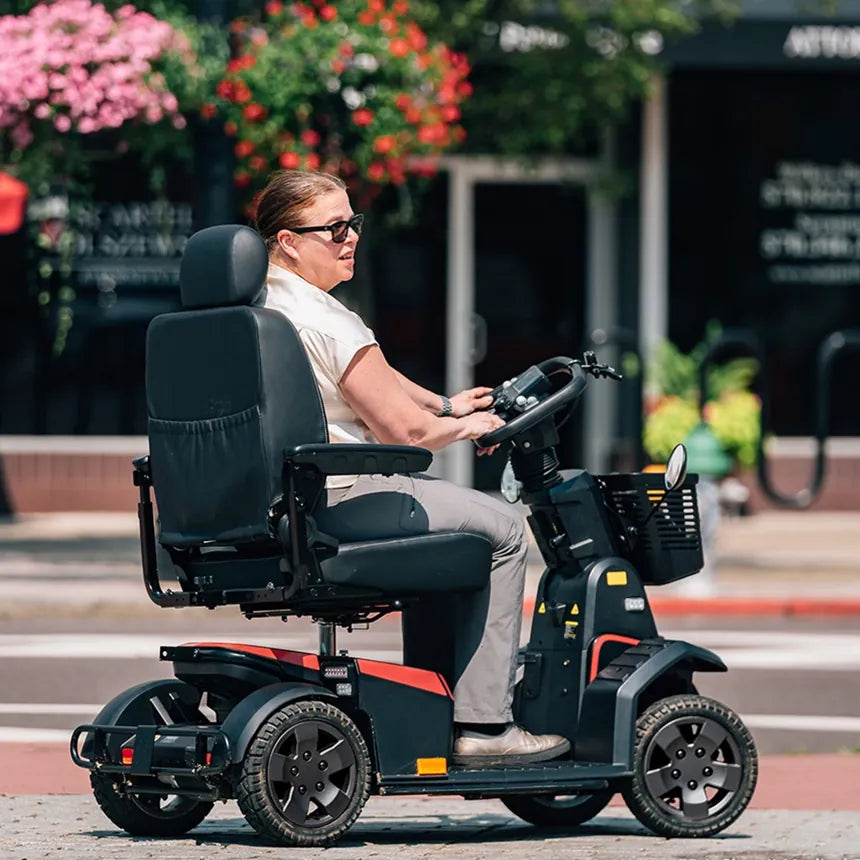 A woman riding a heavy-duty mobility scooter on a city street