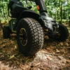 Wrangler 1 Baja Wrangler 2 all-terrain mobility scooter with large wheels, a padded captain’s seat, and high ground clearance, designed for outdoor use and rugged terrain.