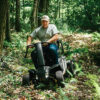 Version 1.0.0 Baja Wrangler 2 all-terrain mobility scooter with large wheels, a padded captain’s seat, and high ground clearance, designed for outdoor use and rugged terrain.