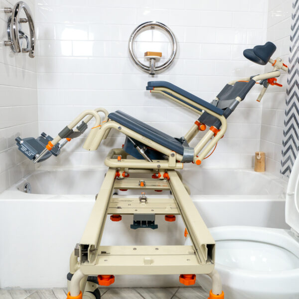 TubBuddy Tilt shower and commode chair with padded seat, adjustable footrests, corrosion-resistant aluminum frame, and tilt-in-space functionality for enhanced comfort.