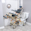 TubBuddy Tilt shower and commode chair with padded seat, adjustable footrests, corrosion-resistant aluminum frame, and tilt-in-space functionality for enhanced comfort.