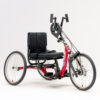 Top End Lil’ Excelerator Handcycle in vibrant red, designed for kids and small adults. The sleek, low-profile frame is equipped with ergonomic hand pedals and three large wheels for stability and smooth maneuverability.