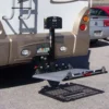 Harmar AL300RV RV Lift mounted on an RV, transporting a scooter with powered lifting and manual fold capabilities.