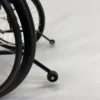 Feather Chair manual wheelchair, ultra-light at 13 lbs, featuring an aluminum frame, large rear wheels, and a foldable design for easy transport and storage.