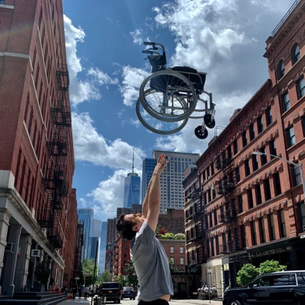 Feather Chair manual wheelchair, ultra-light at 13 lbs, featuring an aluminum frame, large rear wheels, and a foldable design for easy transport and storage.