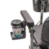 Cup holder attached under the armrest padding of a Pride Mobility scooter, securely holding a beverage for easy access during travel.