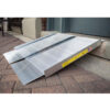 SUITCASE® Singlefold Ramp 8 EZ-ACCESS SUITCASE® Singlefold Ramp fully extended, featuring a slip-resistant surface, ergonomic carrying handles, and lightweight aluminum construction, designed for wheelchairs and scooters."