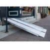 SUITCASE® Singlefold Ramp 9 EZ-ACCESS SUITCASE® Singlefold Ramp fully extended, featuring a slip-resistant surface, ergonomic carrying handles, and lightweight aluminum construction, designed for wheelchairs and scooters."