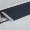 Lightweight EZ-Access TRANSITIONS® Angled Entry Plate, providing safe access for mobility devices over raised thresholds with slip-resistant surface.