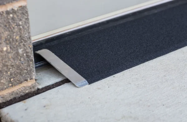 Lightweight EZ-Access TRANSITIONS® Angled Entry Plate, providing safe access for mobility devices over raised thresholds with slip-resistant surface.