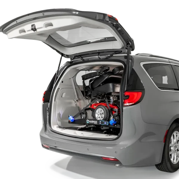 Compact Harmar AL6000 Inside Platform Lift installed in SUV, providing secure transport for powerchairs and scooters.