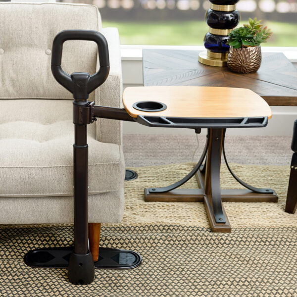 Stander Assist-A-Tray with a swiveling tray and support handle, shown next to a chair for convenient access.
