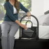 Stander Bed Rail Advantage Traveler, shown folded on a bed, providing secure support for bed transfers at home or on-the-go.