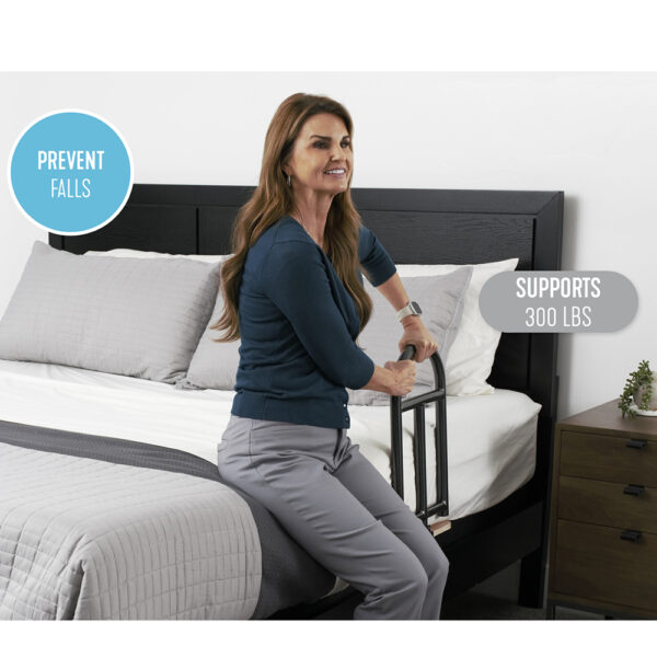 Stander BedCane with cushioned handle and organizer pouch, securely installed on a bed for safe transfers.