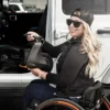 Empulse R90 Power Assist Device attached to a wheelchair, providing lightweight mobility support with a range of up to 9 miles.