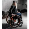Empulse R90 Power Assist Device attached to a wheelchair, providing lightweight mobility support with a range of up to 9 miles.