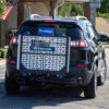 Harmar AL500HD Universal Powerchair Lift on SUV, showing adjustable platform and hold-down arm.