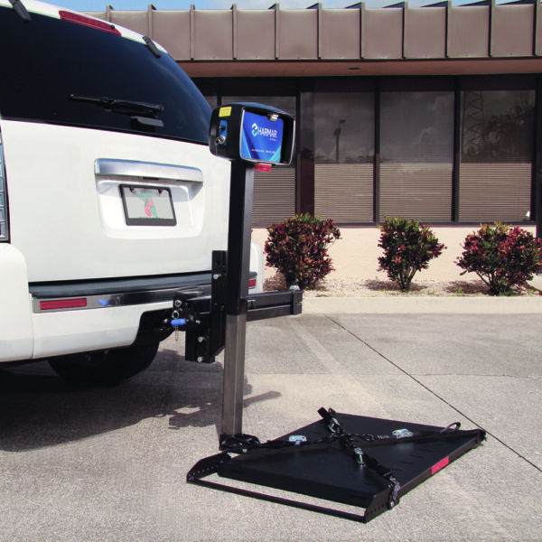 Harmar AL050 Micro Power Chair Lift mounted on a vehicle, showing compact powered lifting and manual fold-away for small powerchairs and wheelchairs.