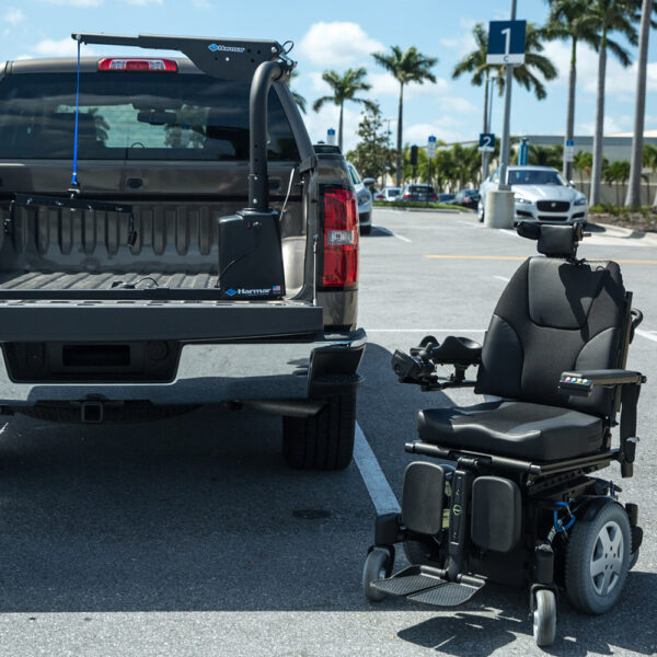 Harmar AL425 Hoist Lift installed in a van cargo area, showcasing powered lifting and rotation for easy mobility device transport.