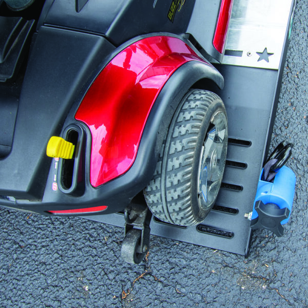 Compact Harmar AL6000 Inside Platform Lift installed in SUV, providing secure transport for powerchairs and scooters.