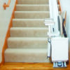 SL350AC_Installed_09_BottomFolded Harmar SL350AC Stairlift installed indoors, showing a wide padded seat, adjustable footrest, and sturdy aluminum track.