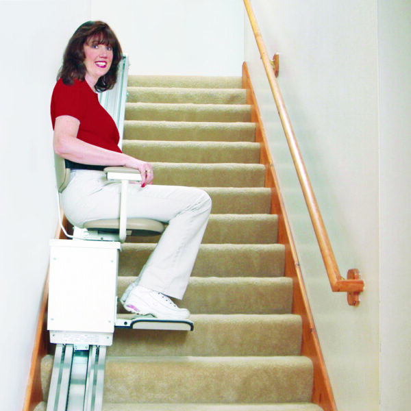 Harmar SL350AC Stairlift installed indoors, showing a wide padded seat, adjustable footrest, and sturdy aluminum track.
