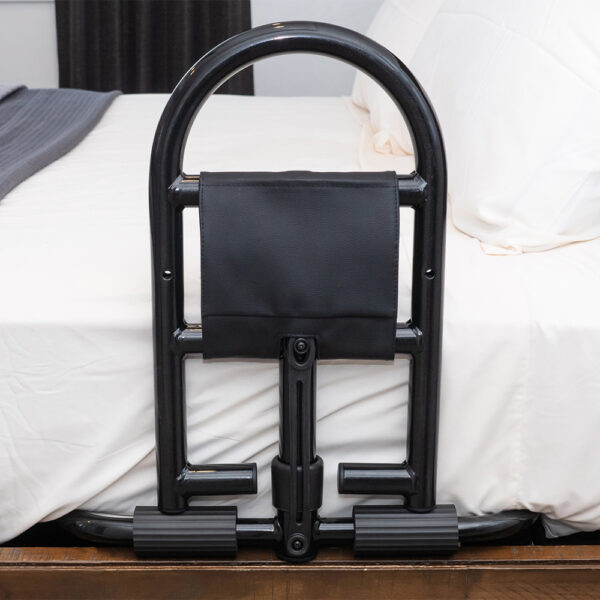 Stander Prime Safety Bed Handle attached to a bed, providing secure, compact support for safe bed transitions.