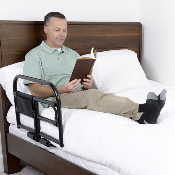 Stander Prime Safety Bed Rail with pivoting design, installed on a bed for extended bedside protection and easy access.