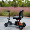 Explorer Mobility Scooter in black and orange, sturdy frame, pneumatic tires, ergonomic handlebars, and control panel for easy operation.