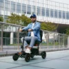 Explorer Mobility Scooter in black and orange, sturdy frame, pneumatic tires, ergonomic handlebars, and control panel for easy operation.