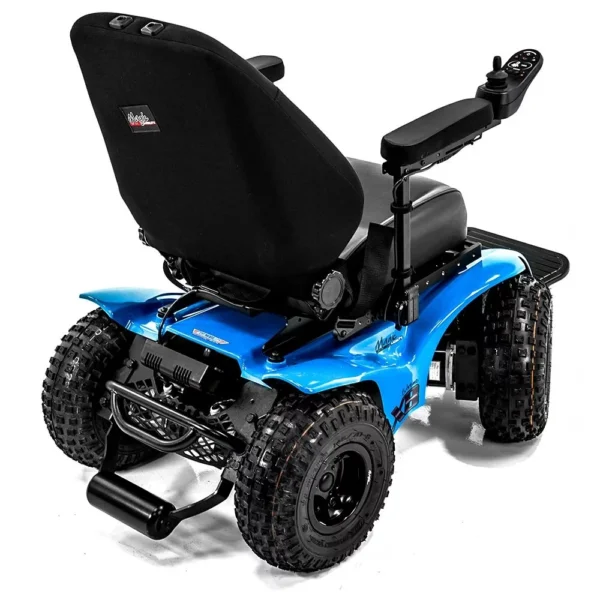 Extreme X8 Power Wheelchair navigating rugged outdoor terrain with knobby tires and a sturdy design, built for sand, snow, and off-road adventures.