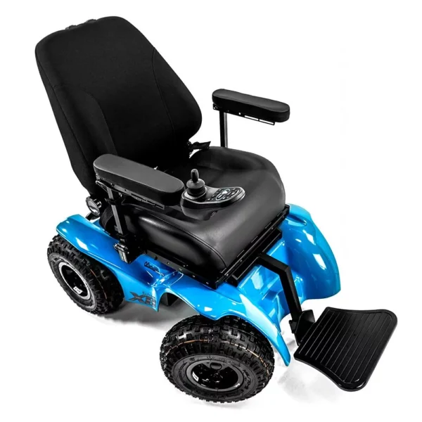 Extreme X8 Power Wheelchair navigating rugged outdoor terrain with knobby tires and a sturdy design, built for sand, snow, and off-road adventures.