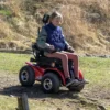 Extreme X8 9 Extreme X8 Power Wheelchair navigating rugged outdoor terrain with knobby tires and a sturdy design, built for sand, snow, and off-road adventures.