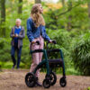 Rollz Motion Performance, an all-terrain rollator and wheelchair combo with air-filled tires, wedge-shaped seat, and reflective accents for outdoor adventures.