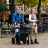Rollz Motion Performance, an all-terrain rollator and wheelchair combo with air-filled tires, wedge-shaped seat, and reflective accents for outdoor adventures.