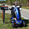 Vita Monster all-terrain mobility scooter in midnight black, featuring 15” rear tires, 900-watt motor, LED lights, and sporty captain's seat for outdoor performance.