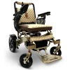 IQ7000_Bronze_Frame_Coffee_Textile Majestic IQ‑7000 electric wheelchair with remote control, padded seat, folding frame, and large rear wheels—ideal for travel and everyday use.