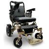 IQ7000_Bronze_Frame_Gray_Textile Majestic IQ‑7000 electric wheelchair with remote control, padded seat, folding frame, and large rear wheels—ideal for travel and everyday use.